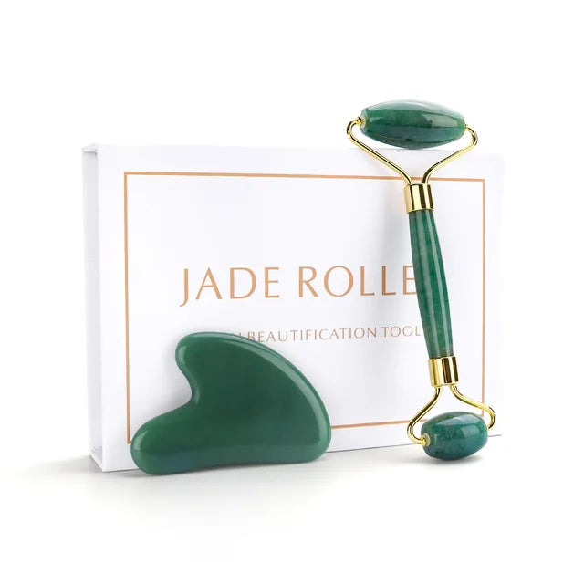 Jade roller with gold accents on a white background
