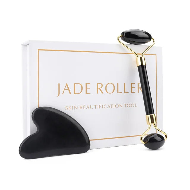 Jade roller with black stones on a white background