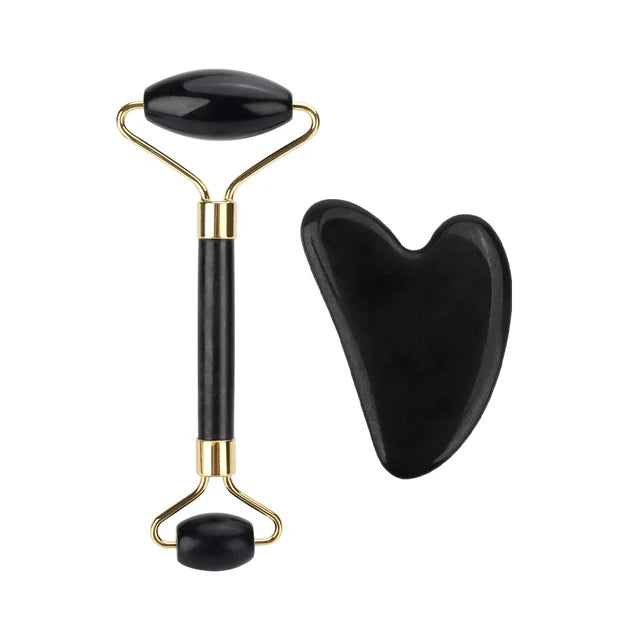 Black and gold facial roller with heart-shaped gua sha tool on a white background
