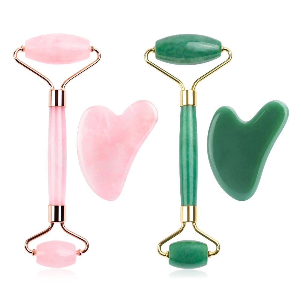 Two jade rollers and two heart-shaped gua sha tools, one pink and one green, on a white background.