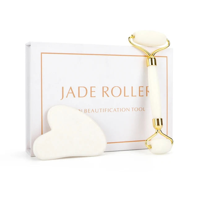 Jade roller with gold accents on a white background